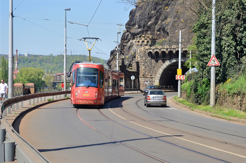 20 - A red Tatra T3R.PLF tram exiting the historic Vyšehrad Tunnel along the Vltava riverbank in Prague